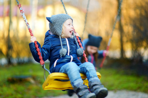 Smiling child on a swing