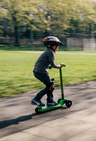 a child riding on a scooter