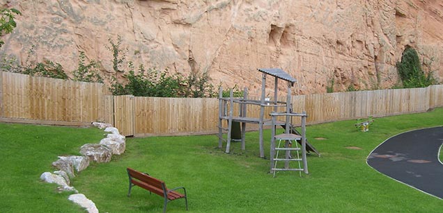 Children's play area overlooked by SINC cliff face
